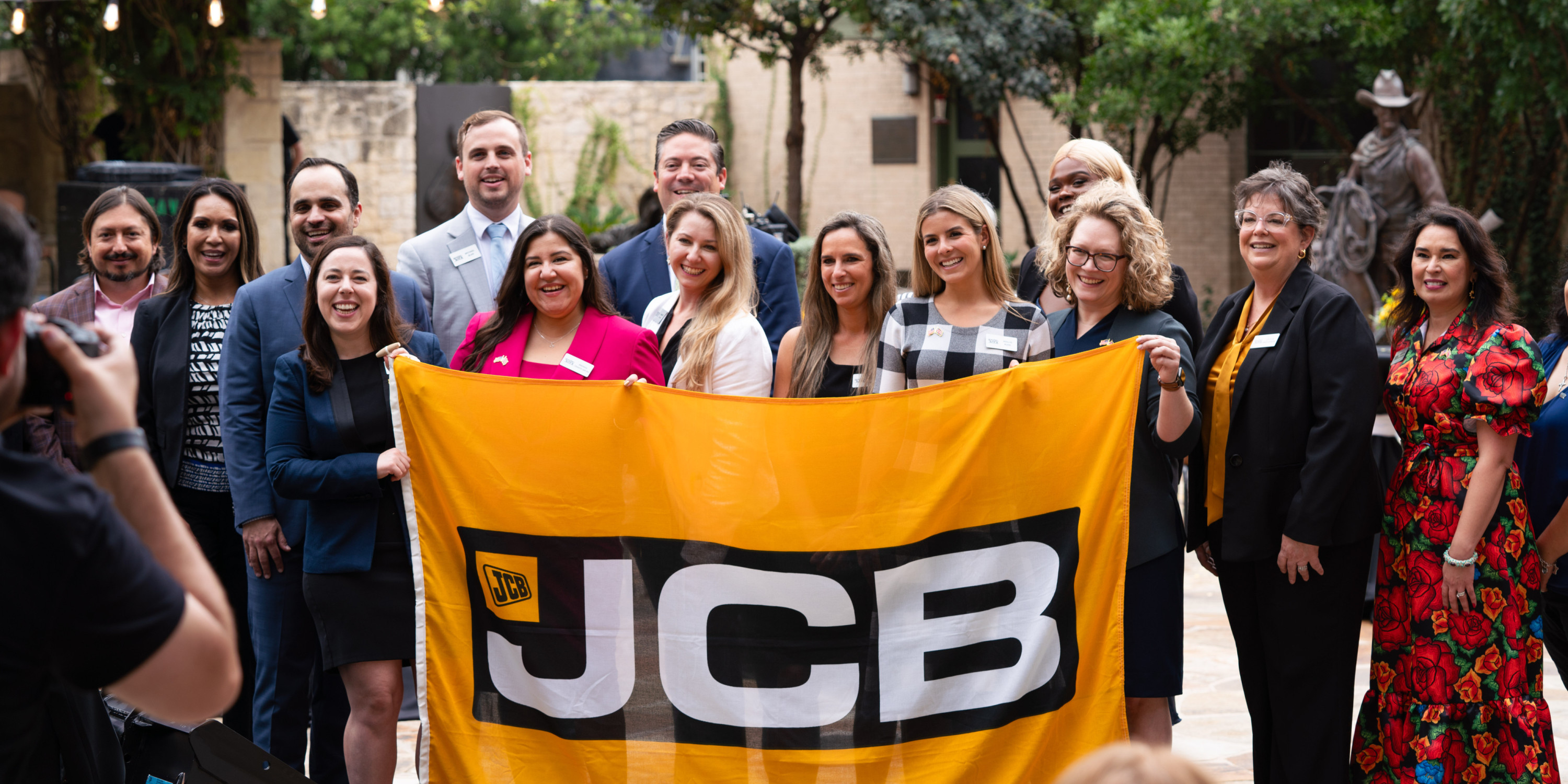 people holding up JCB flag