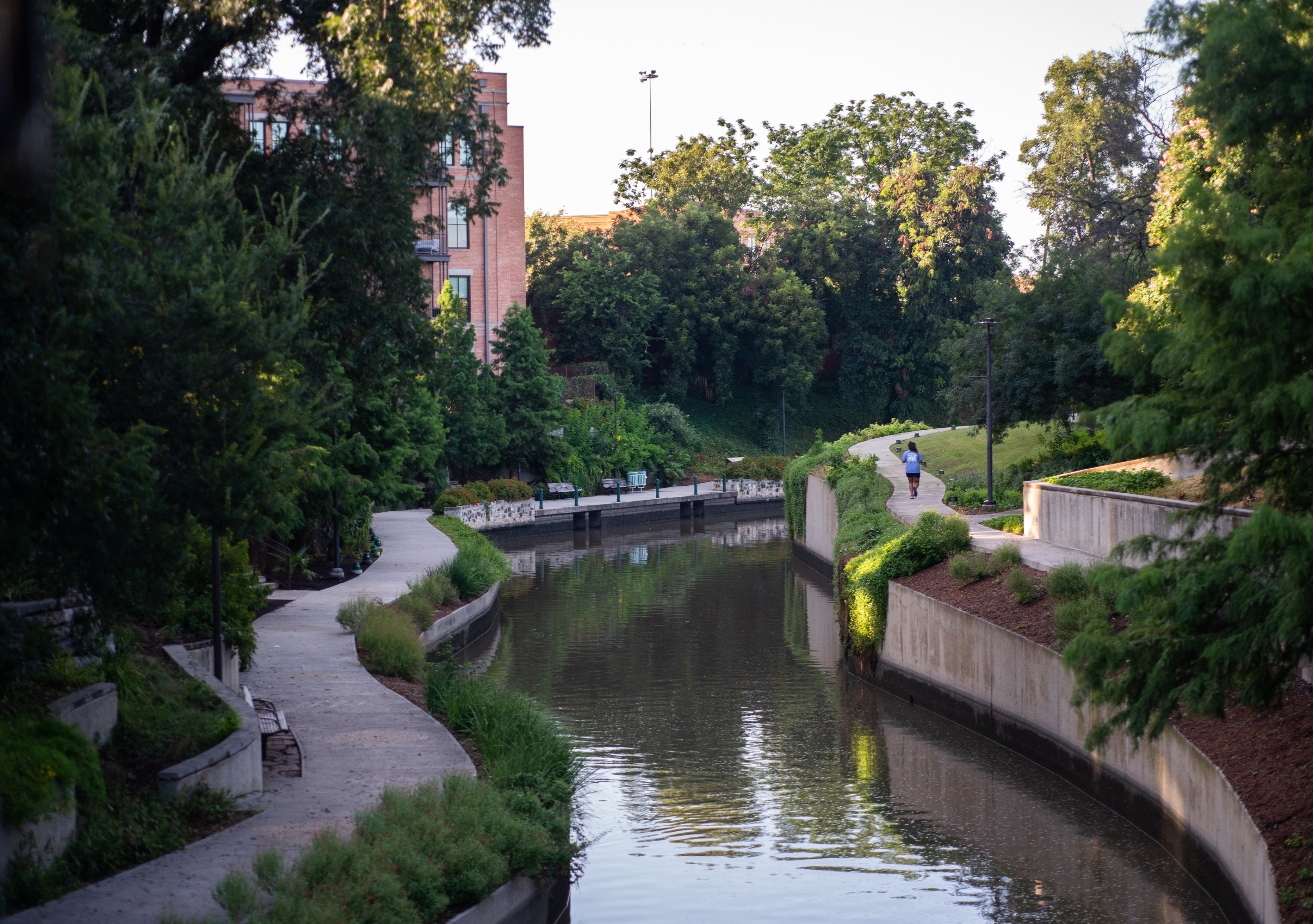 person jogging on riverwalk