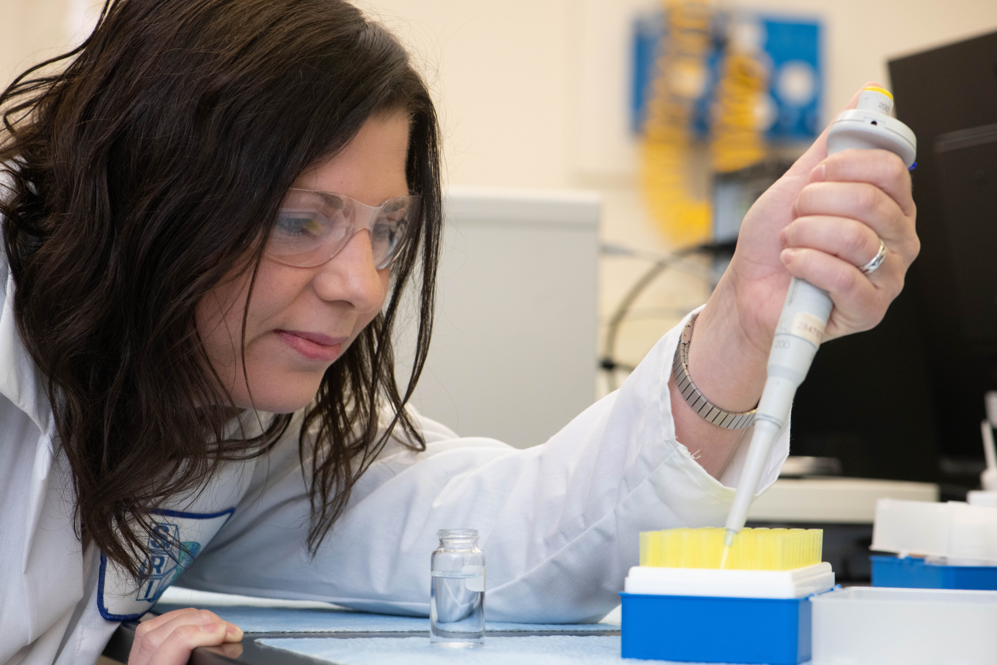 woman putting samples into test vials