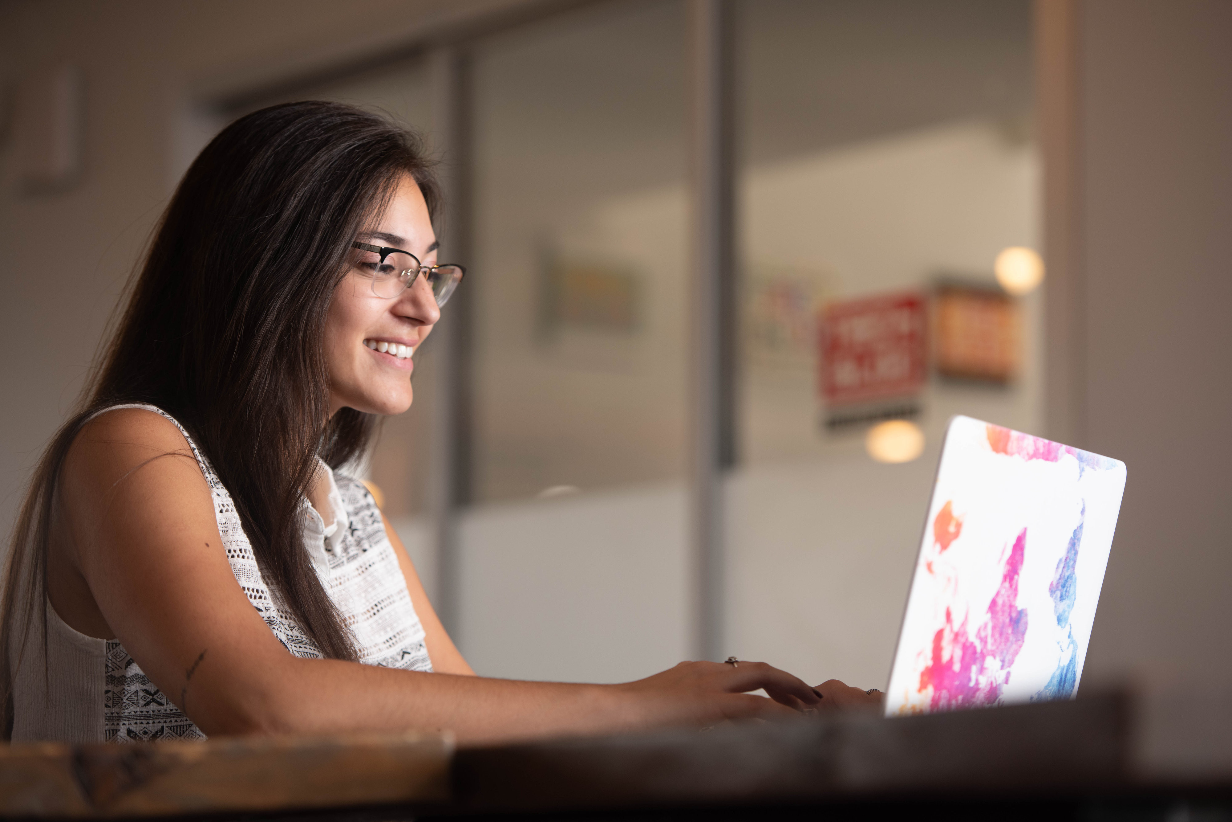 Woman working on a laptop computer.